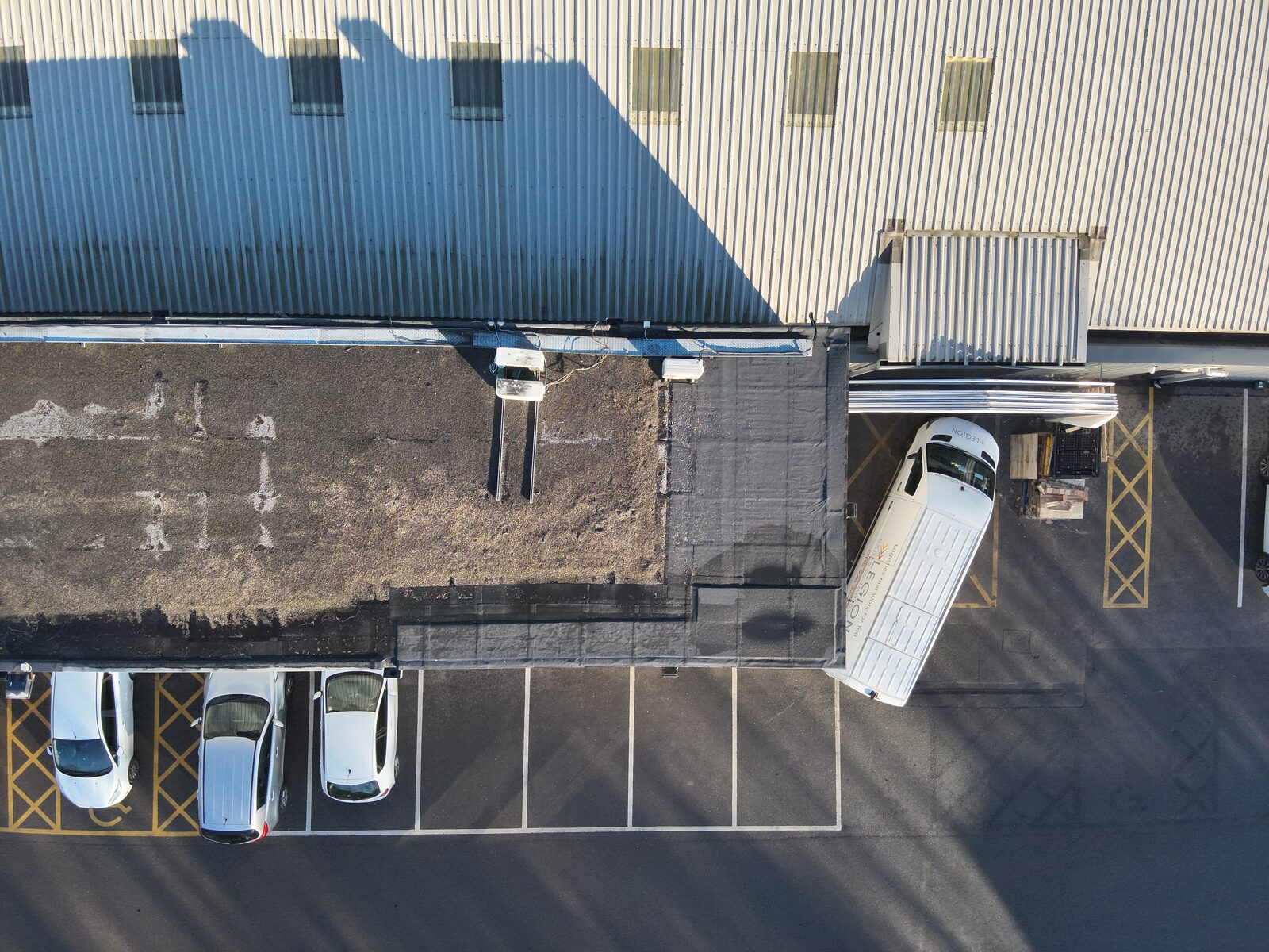 Real drone RGB aerial photo of a commercial flat roof, captured for a SkyReports moisture survey